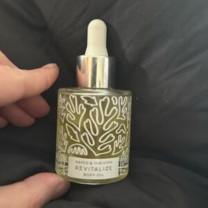 Naked & Thriving Revitalize nourishing body oil, liquid is lower than normal….